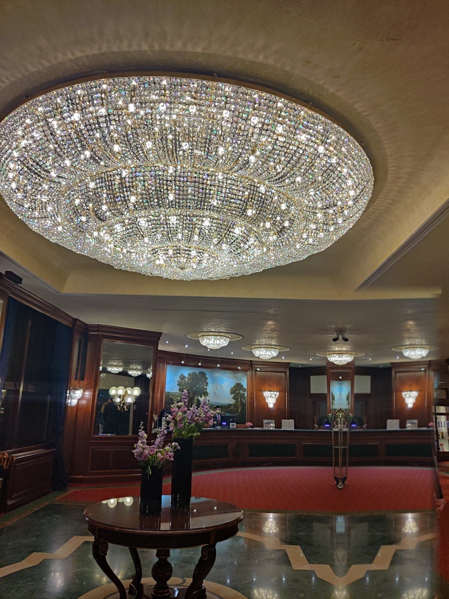 Hotel lobby viewed from below the grand crystal chandelier