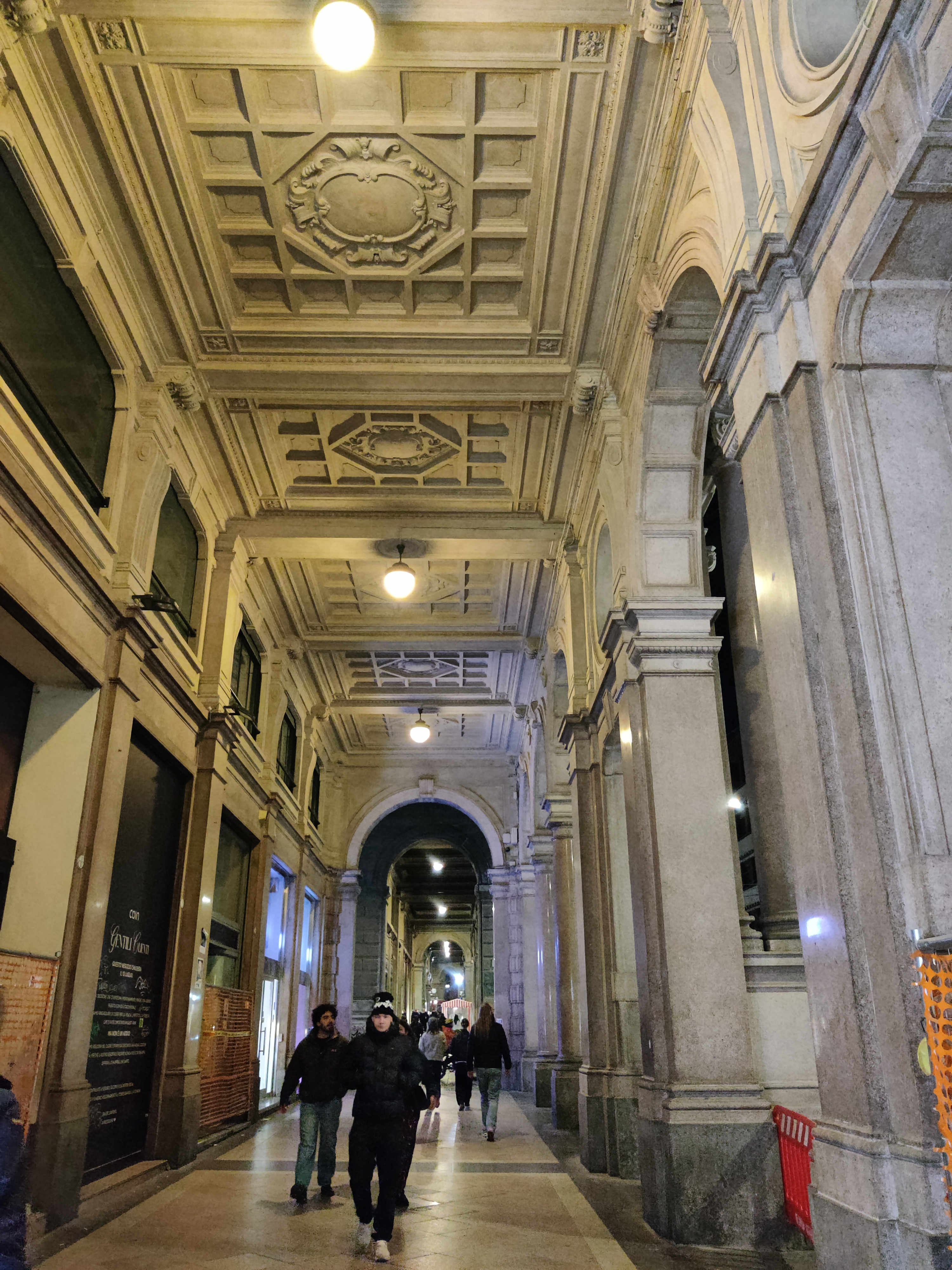 Elegant Renaissance portico with ornate coffered ceiling and tall classical columns at night